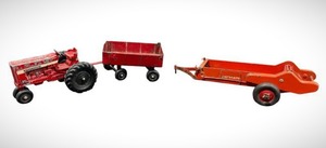 lot 107 image: Set of Vintage Farm Toys Including International Tractor, McCormick-Deering Spreader (10.5 long), and an ERTL 4-Wheel Utility Trailer