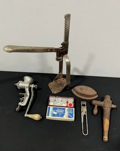 lot 109 image: Lot of Unique and Vintage Items - Cork Stuffer, Sad Iron, Meat Grinder, Old Fashion Bottle Opener, Wooden Barrel Spigot, and Original Clothes Line Grippers