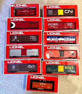 lot 26 image: Lionel Freight Train Box Cars- Red Box including Lionel Canadian Pacific Lighted Caboose Train Car