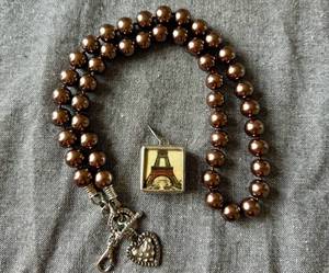 lot 66 image: Jewelkade Brown Faux Pearl Necklace and Fleur De Lis - Eiffel Tower Charm