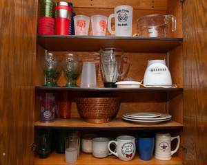 lot 105 image: Kitchen Cabinet Contents  Blender, Mugs, Plastic Cups, Glass Goblets & More