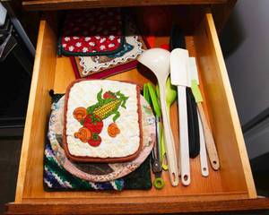 lot 136 image: Kitchen Drawer Contents  Hotpads & Mixing Utensils