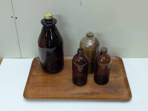 lot 15 image: Brown Bottle Set on Old Wood Serving Tray - 4 Bottles 1 Board