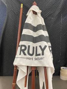 lot 52 image: Truly Hard Seltzer Patio Umbrella with Wooden Stand