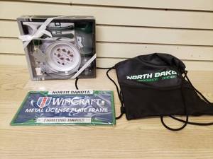 lot 32 image: Fighting Hawks String Backpack, Fighting Hawks License Plate Frame and The Wild Newborn Necessities Gift Set