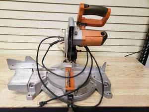 lot 82 image: Ridgid compound miter saw, powered up handle has been glued