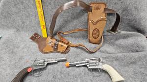 lot 77 image: 2 Vintage Child Gun Holsters and Cap Guns