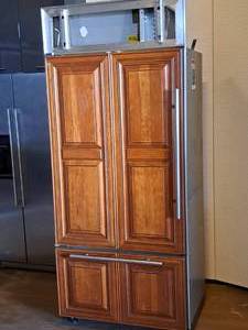lot 1 image: Sub-Zero Model 650 Refrigerator with Bottom Drawer Freezer Wood Grain Panel Finish