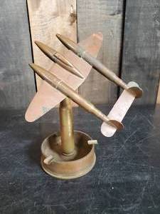 lot 46 image: THIS IS AWESOME  Metal WWII Trenchart Shell Caseing Ashtray and Shell Plane that Balances on the top