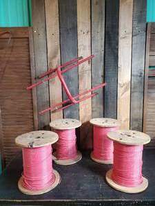 lot 117 image: 4 Partial Spools of Wire and Metal Wall Hanging spool Holder, Please Refer to Pictures for Wire Size and Gauge