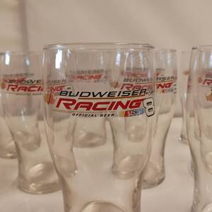 lot 11 image: A full case of (24 total glasses) of Budweiser Racing Dale Earnhardt Jr. 11 pcs Collector Beer Glasses - 16 oz each.