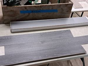lot 320 image: Lot of (45 Boxes) 858-sq.ft. LVP Waterproof Rigid Core Luxury Vinyl Click Plank Flooring with Pad 5mmx7.15x47.75  23.71-sq.ft. GEN2117RIG 10-count ( 450 total items ) (Iron Ore)