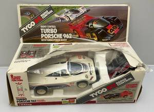 lot 78 image: Vintage TYCO RC Radio Control Turbo Porshe 962 With Turbo Power Boost Preowned In Original Box (Box Beat Up, missing Battery Cover On Remote & Antenna, Battery Box On Car Corroded)