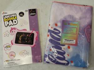 lot 9 image: For the Unicorn Lovers (1) Grafix Unicorn Doodle Pad & (1) Unicorn Kids Bath & Beach Towel (View Photos)
