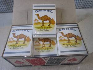 lot 99 image: (EC1) 12 New Decks Camel Cigarettes...