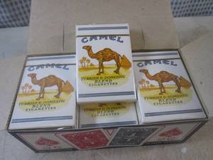 lot 100 image: (EC1) 12 New Decks Camel Cigarettes...