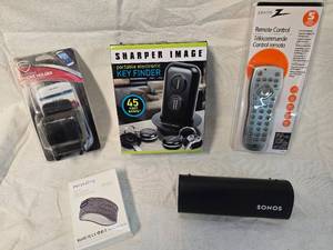 lot 174 image: Sharper Image Key Finder, Universal Remote Control, Phone Holder, Wireless Headband Headphone, Bluetooth Speaker