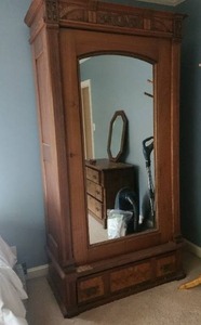 Antique Wooden Armoire with Intricate Carvings and Mirror
