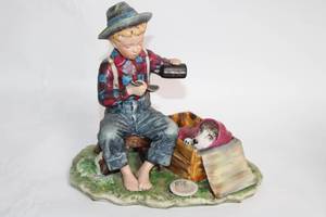 lot 19 image: Vintage Porcelain Figurine of Boy Feeding Puppy