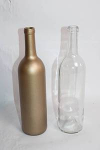 lot 82 image: Set of 2 Decorative and Clear Glass Bottles
