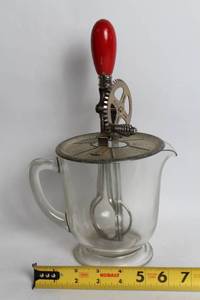 lot 234 image: Vintage Glass Hand Mixer with Red Handle and Measuring Cup