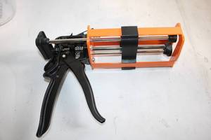 lot 283 image: Industrial Grade Caulking Gun with Orange Frame