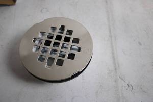 lot 251 image: Westbrass Round Shower Grate with 2 in. PVC Body and Key
