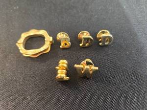 lot 109 image: Collection of Gold Tone Initial Tie Tacks and Necklace Cluster Holder