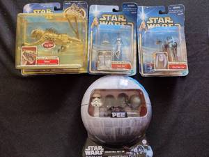 lot 106 image: Hasbro starwars figures and Pez Dispensers in original boxes.