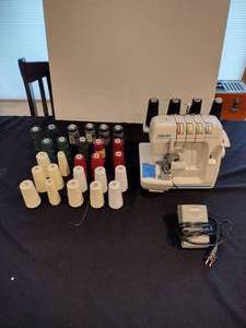 lot 161 image: Baby lock protg sewingserger machine with 26 rolls of thread