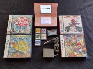 lot 194 image: Nintendo DS (pink) and 9 games