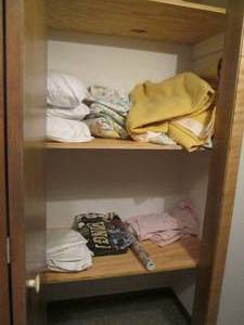 lot 37 image: Closet filled with blankets and bed...