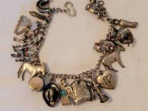 lot 125 image: Sterling Silver Southwestern Theme Charm Bracelet  45g