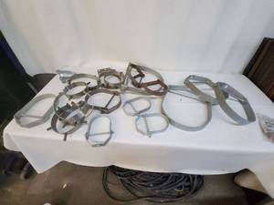 lot 31 image: Collection of  Large Pipe Hangers,  Hose Clamps and Couplers
