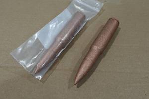lot 125 image: 2 Copper Novelty 50 BMG Rounds