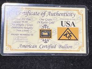 lot 22 image: ONE GRAIN OF 24 KARAT GOLD IN CARD