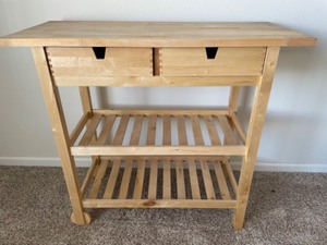 lot 108 image: Wood Butcher Block Kitchen Stand with Drawers and Wheels on One End