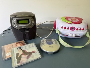 lot 176 image: 1990s Strawberry Shortcake CD PlayerStereo, Phillips CD PlayerStereo, and Panasonic Portable Player