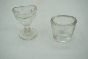 lot 8 image: Vintage eyeglass cleaner jars