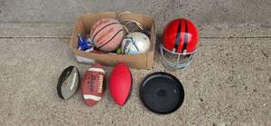 lot 34 image: Collection of Used Sports Equipment Basketball, Soccer Ball, Footballs, and Helmet