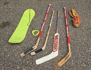 lot 74 image: Set of Vintage Hockey Sticks, Baseball Gloves, and More