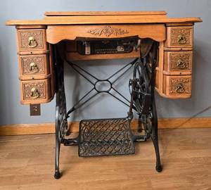 lot 189 image: Antique Minnesota Model B Sewing Machine with Treadle and Oak Cabinet