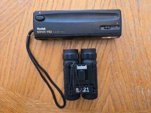 lot 275 image: Kodak STAR 110 Camera and Bushnell 8x21 Binoculars with Case