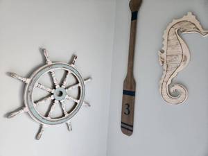 lot 61 image: Nautical Wall Decor Set with Ship Wheel, Oar, and Seahorse