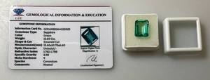 lot 37 image: GIE Labs (Lab Created) 12.60 Ct Emerald Cut Green Sapphire With Card (In Protective Case)