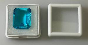 lot 43 image: 22.60 CT (Lab Created) Emerald Cut Sky Blue Topaz  (In Protective Sleeve)