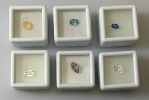 lot 51 image: Misc. (Lab Created) Gems (In Protective Sleeves) Including 1.1Ct Pink Amethyst, 1.14 CT Blue Zircon, 1.17 Ct. Sky Blue Topaz, 1.5 CT White Topaz, 2.09 CT Blue Kyadite & More