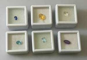 lot 55 image: Misc. (Lab Created) Gems (In Protective Sleeves) Including 1.1Ct Pink Amethyst, 1.14 CT Blue Zircon, 1.17 Ct. Sky Blue Topaz, 1.5 CT White Topaz, 2.09 CT Blue Kyadite & More