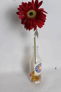lot 287 image: Vintage Ne-Time Cola Bottle with Artificial Red Gerbera Flower