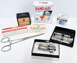 lot 199 image: Vintage Medical Supply Collection including Glass Syringes, Bandages, and Instruments